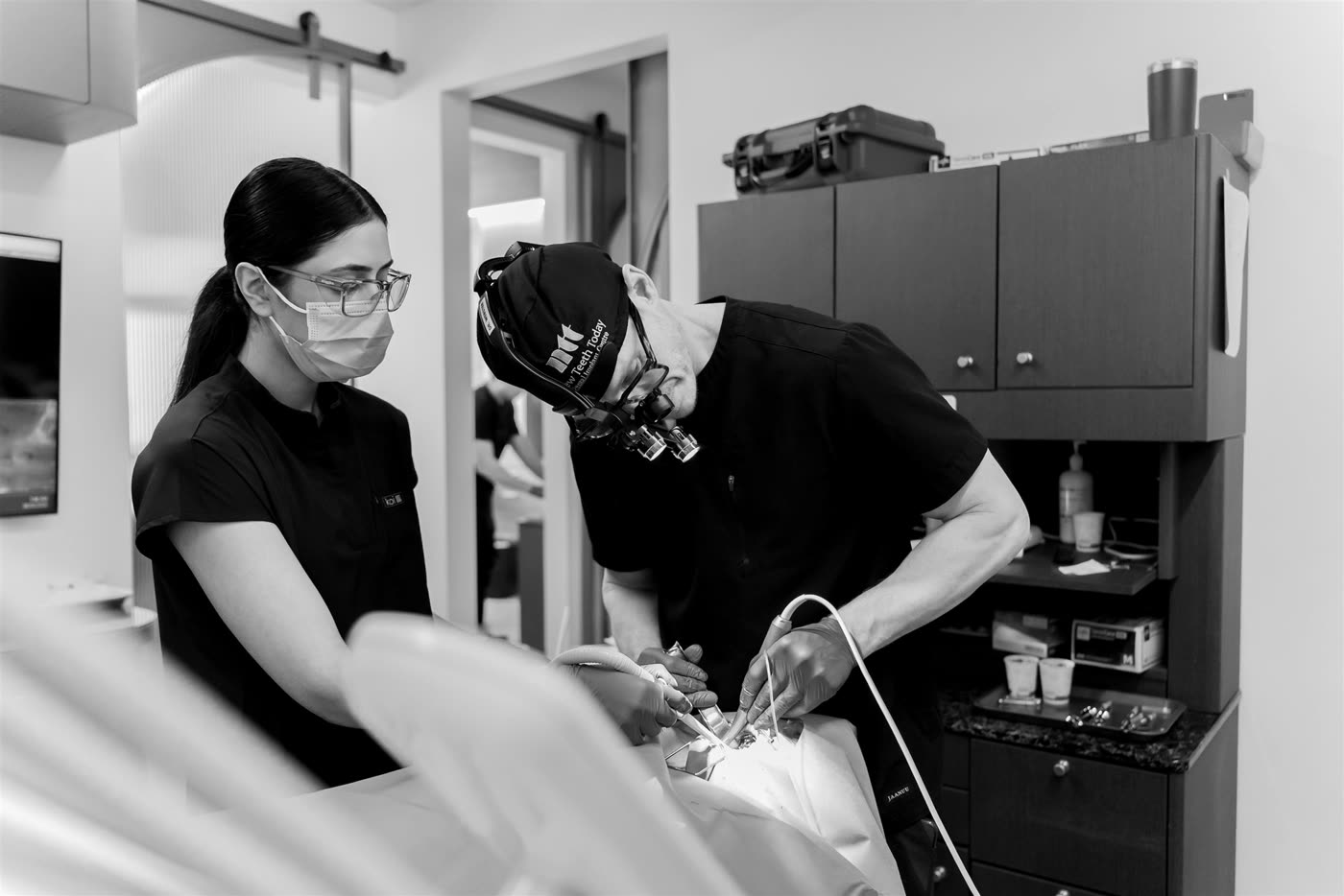 Two clinicians working chairside.