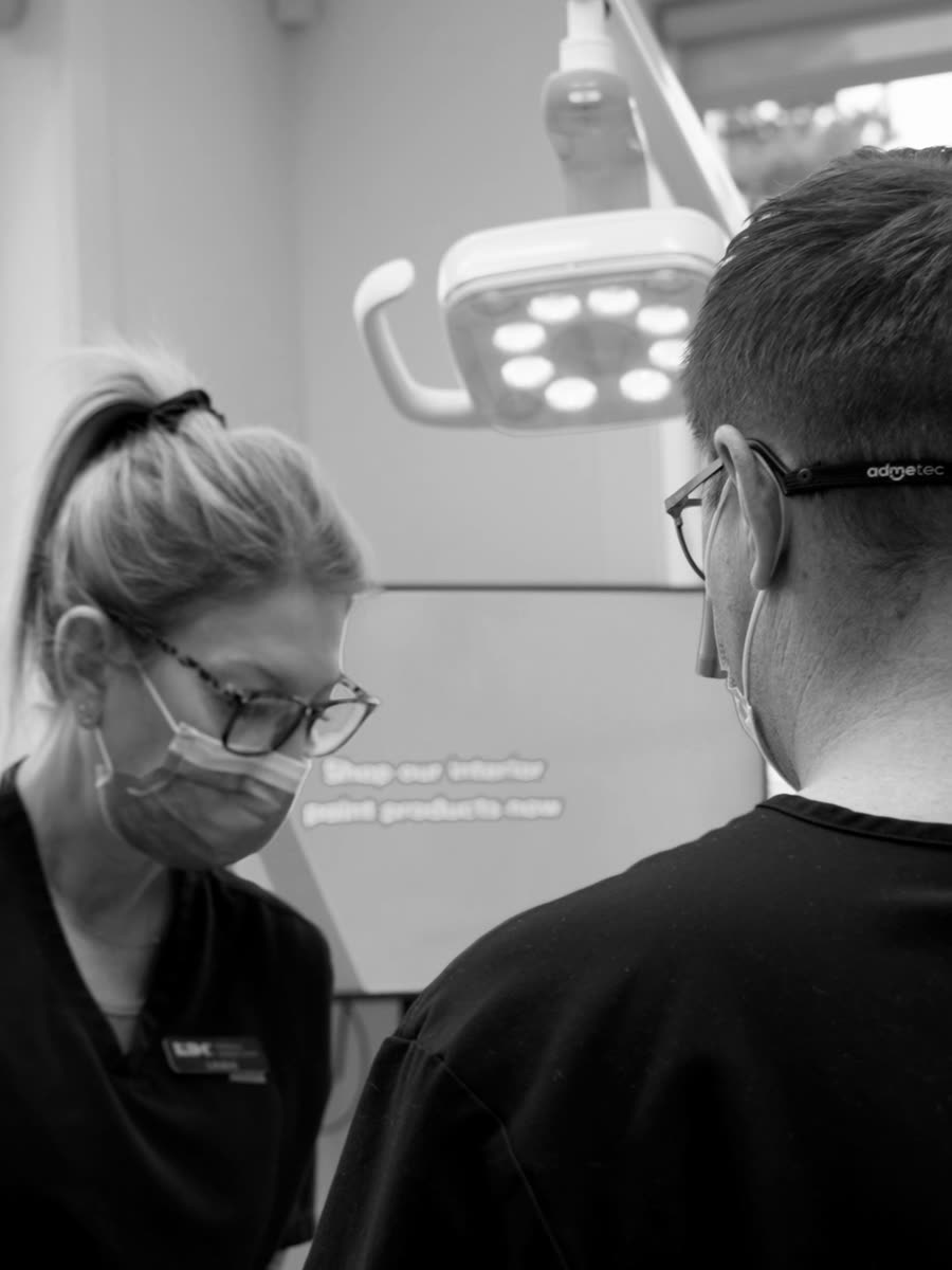 A clinician working chairside with a patient.
