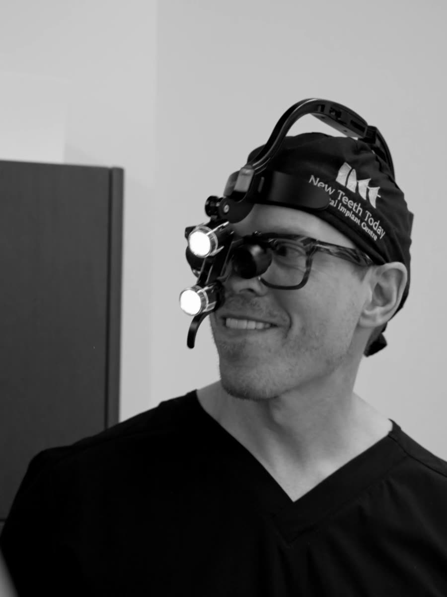 A clinician in a surgical headlamp and loupes.